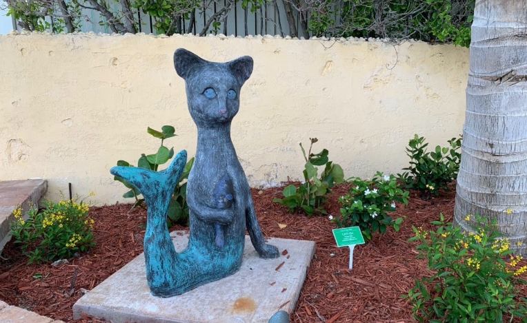 cat statue with butterfly on nose