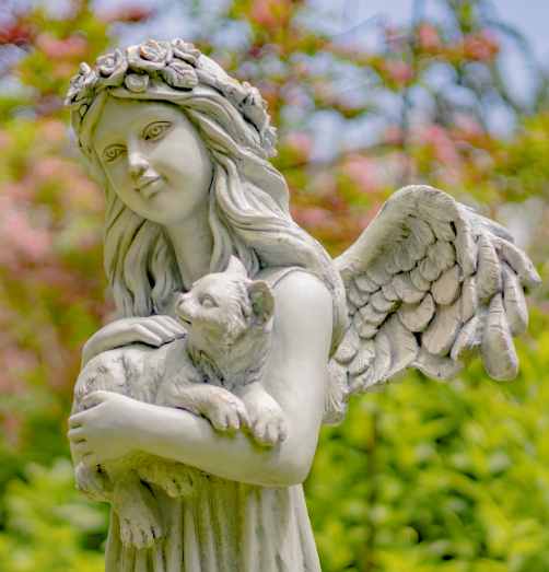angel holding cat figurine