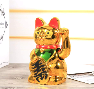 cat statue with waving paw