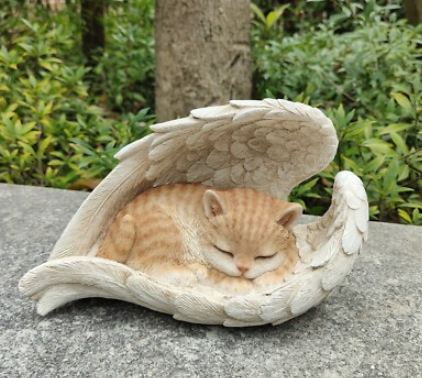 angel holding cat statue