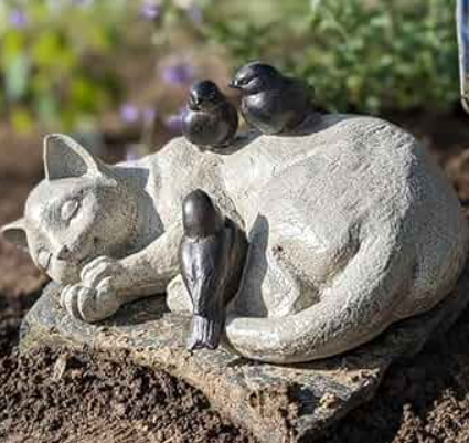 cats sleeping on statues