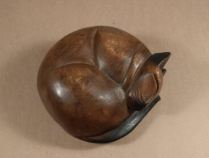 curled up cat statue