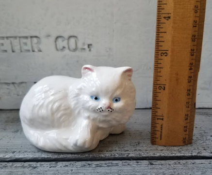 white porcelain cat statue